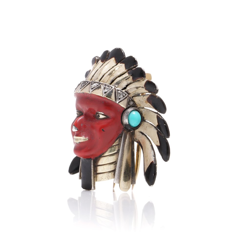 Cartier brooch in gold, silver and enamel set with gem.