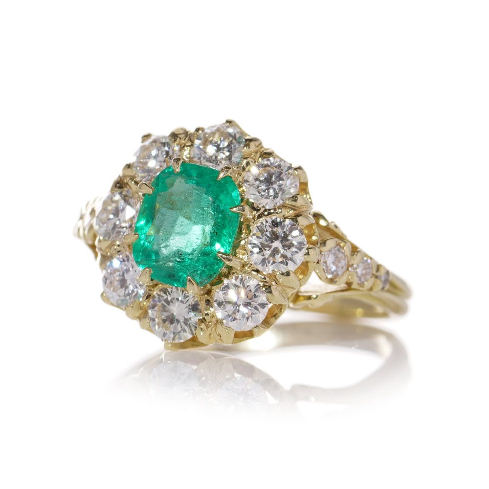 Emerald and diamond cluster ring in gold.