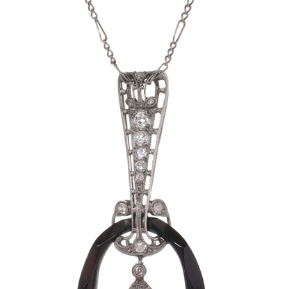 Antique platinum pendant necklace with pearl, onyx, and diamonds.