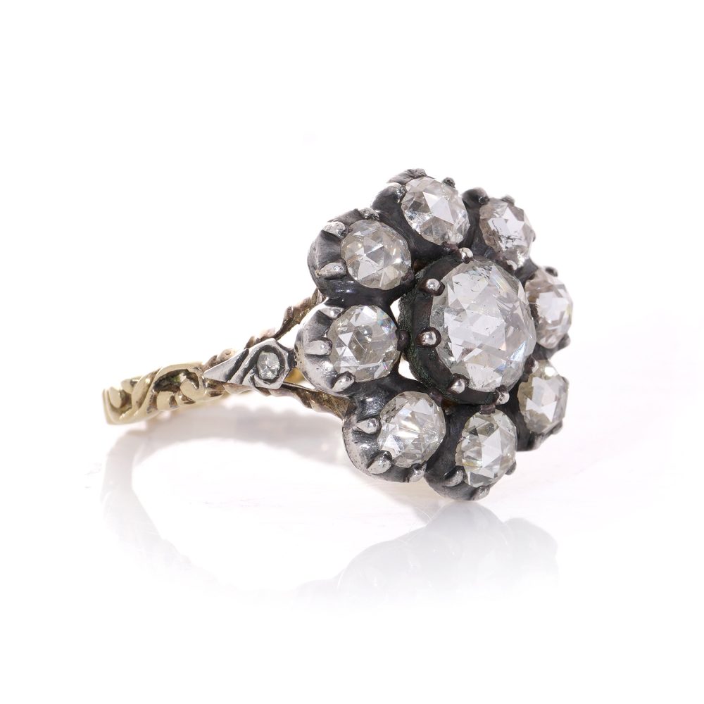 Diamond daisy cluster ring in gold and silver.