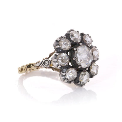 Diamond daisy cluster ring in gold and silver.