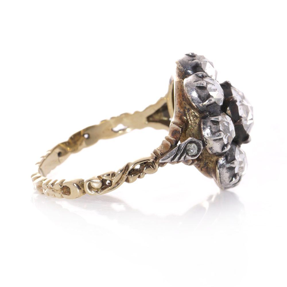 Diamond daisy cluster ring in gold and silver.