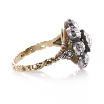 Diamond daisy cluster ring in gold and silver.