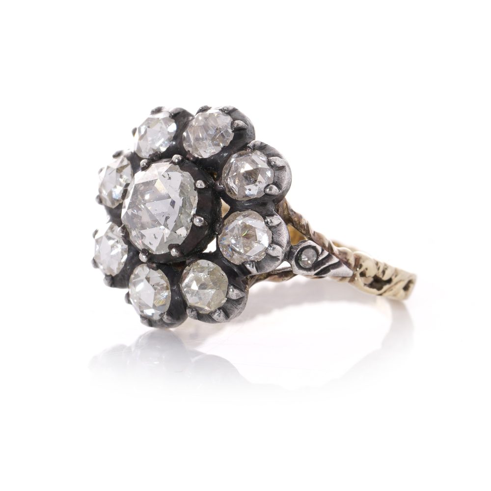 Diamond daisy cluster ring in gold and silver.