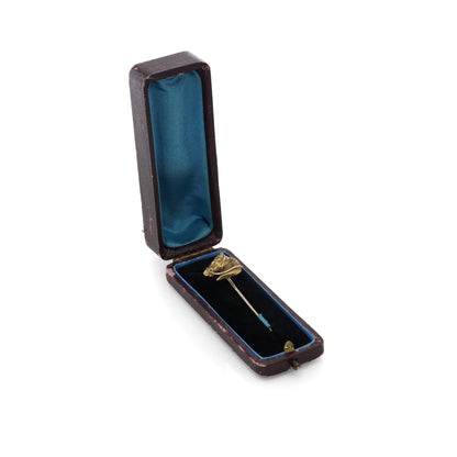 A yellow gold tie or stick pin featuring a horse's head, in an antique fitted box, on a white background