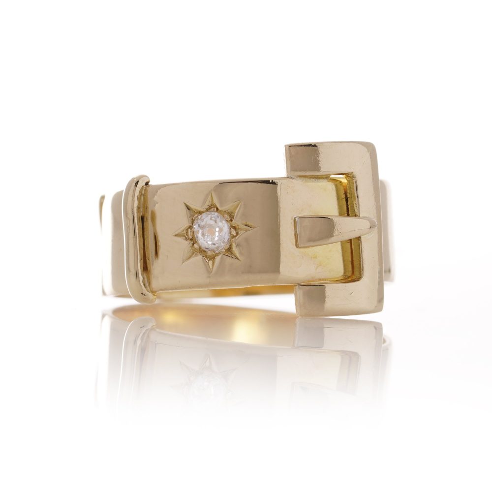 Antique men's belt buckle gold ring accented a diamond.