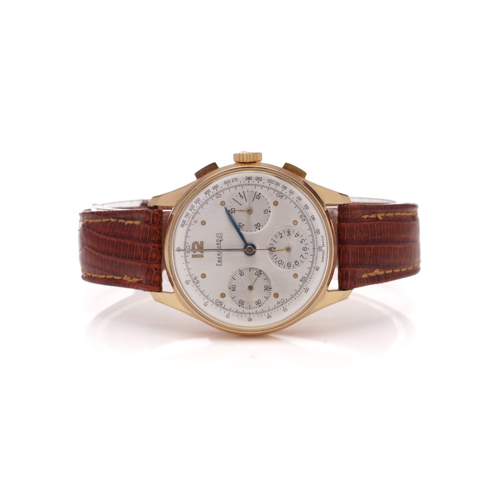 Vintage Eberhard 18ct Gold Mechanical Chronograph Watch, 35mm round gold case with white dial with three sub-dials and tachymeter scale, on brown leather strap. Circa 1950s