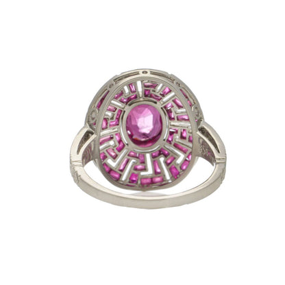 Platinum oval ruby cluster ring surrounded by rubies diamonds.