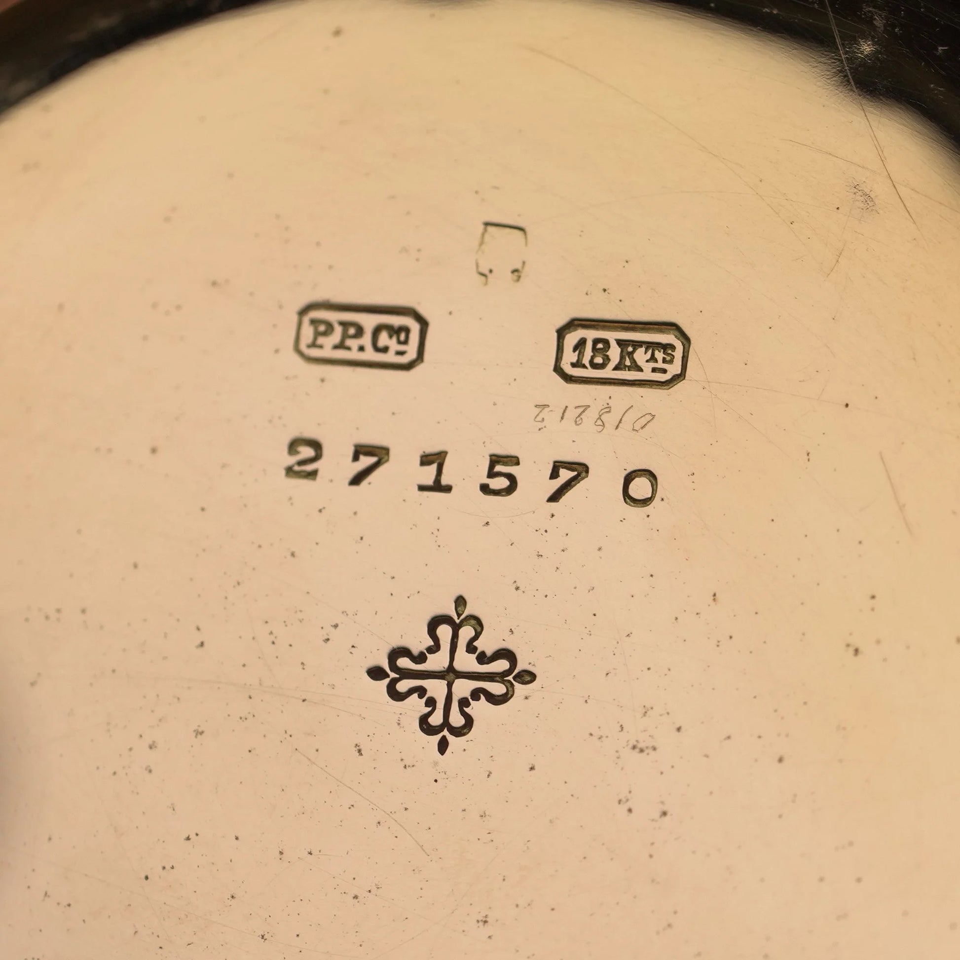 Close-up of a yellow gold watch case back stamped PP.Co 18KTS 271570