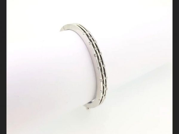 Diamond Bangle; Triple row of interspersed round cut diamonds set into an 18ct white gold bangle. A delicate and chic piece of jewellery