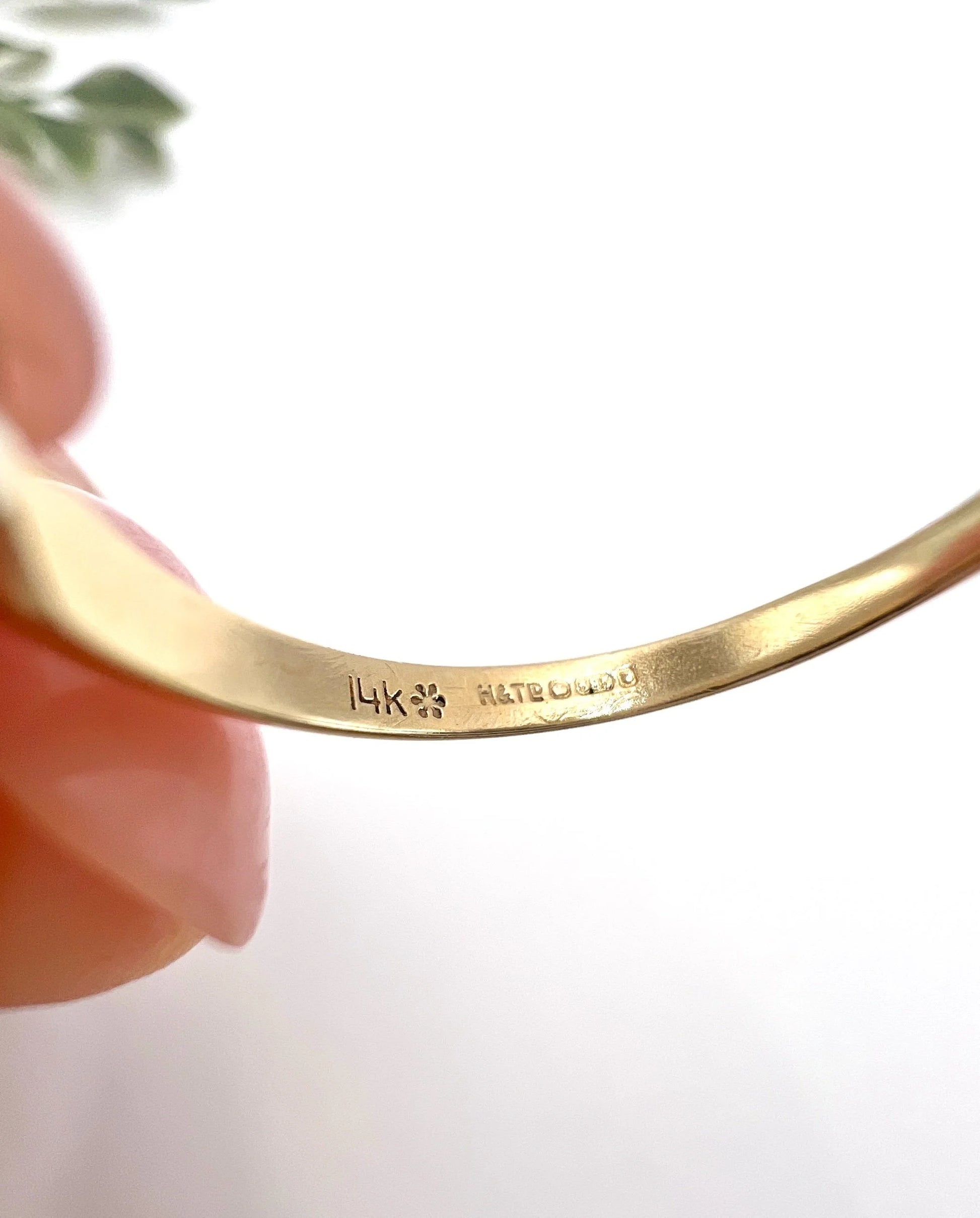 Close-up of stamps inside a yellow gold ring shank