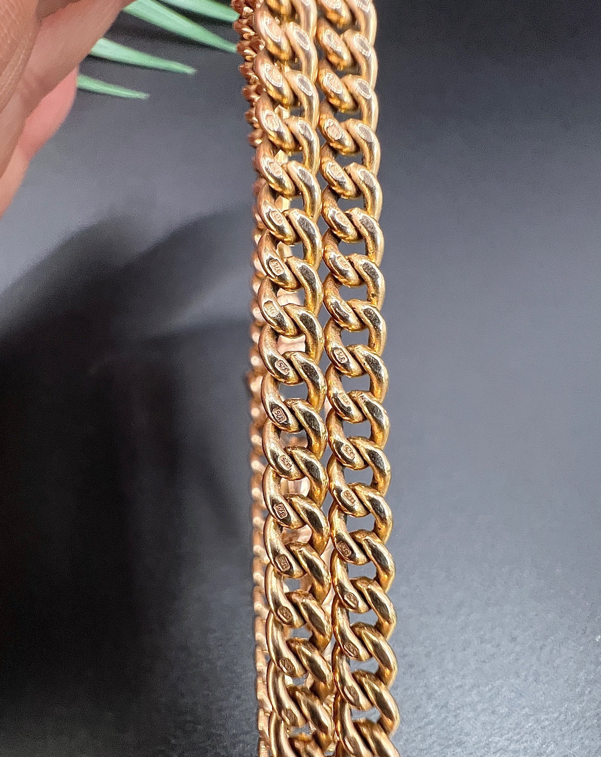 Close-up of gold curb links