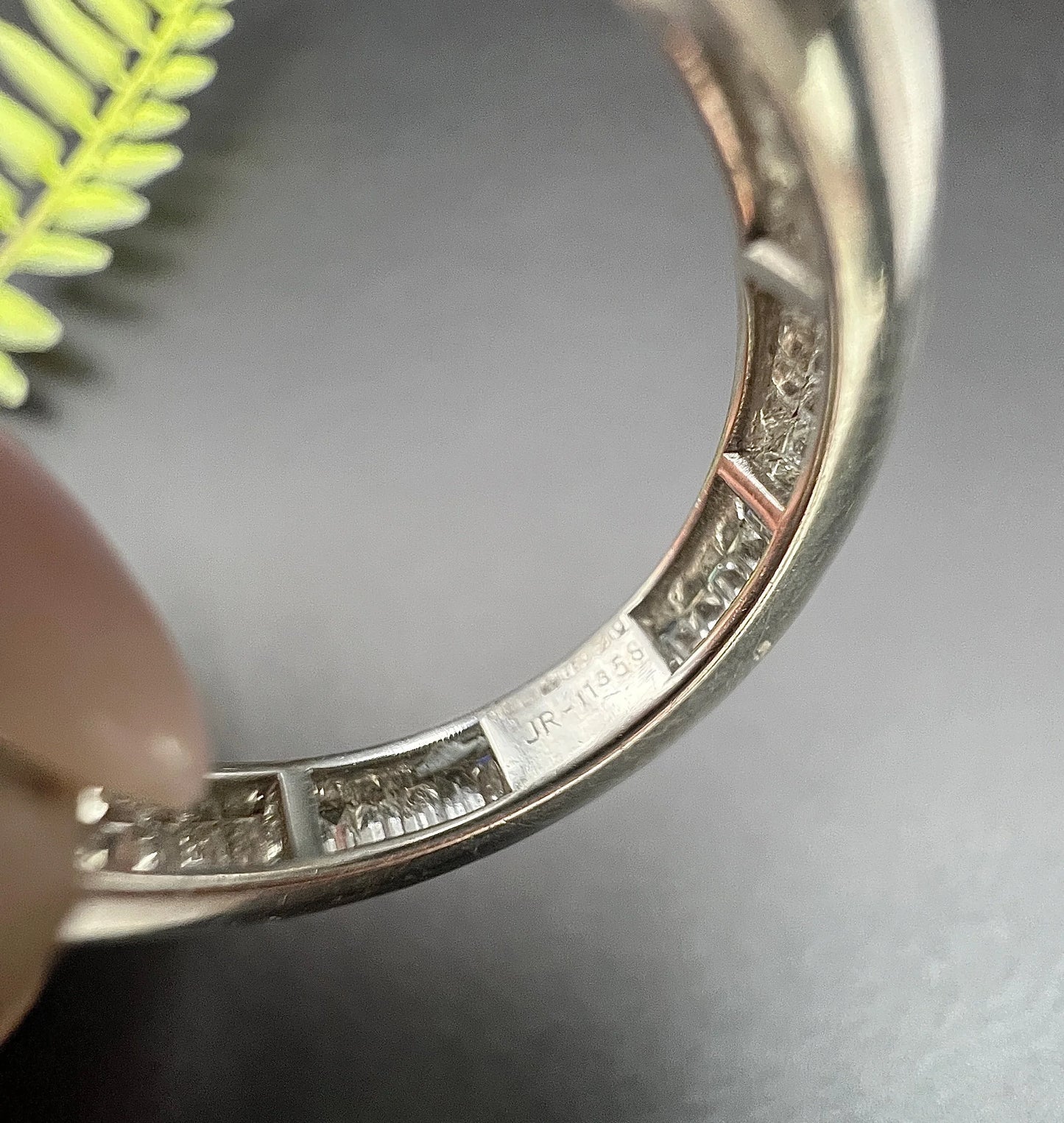 A close-up of a stamp inside a white gold ring band