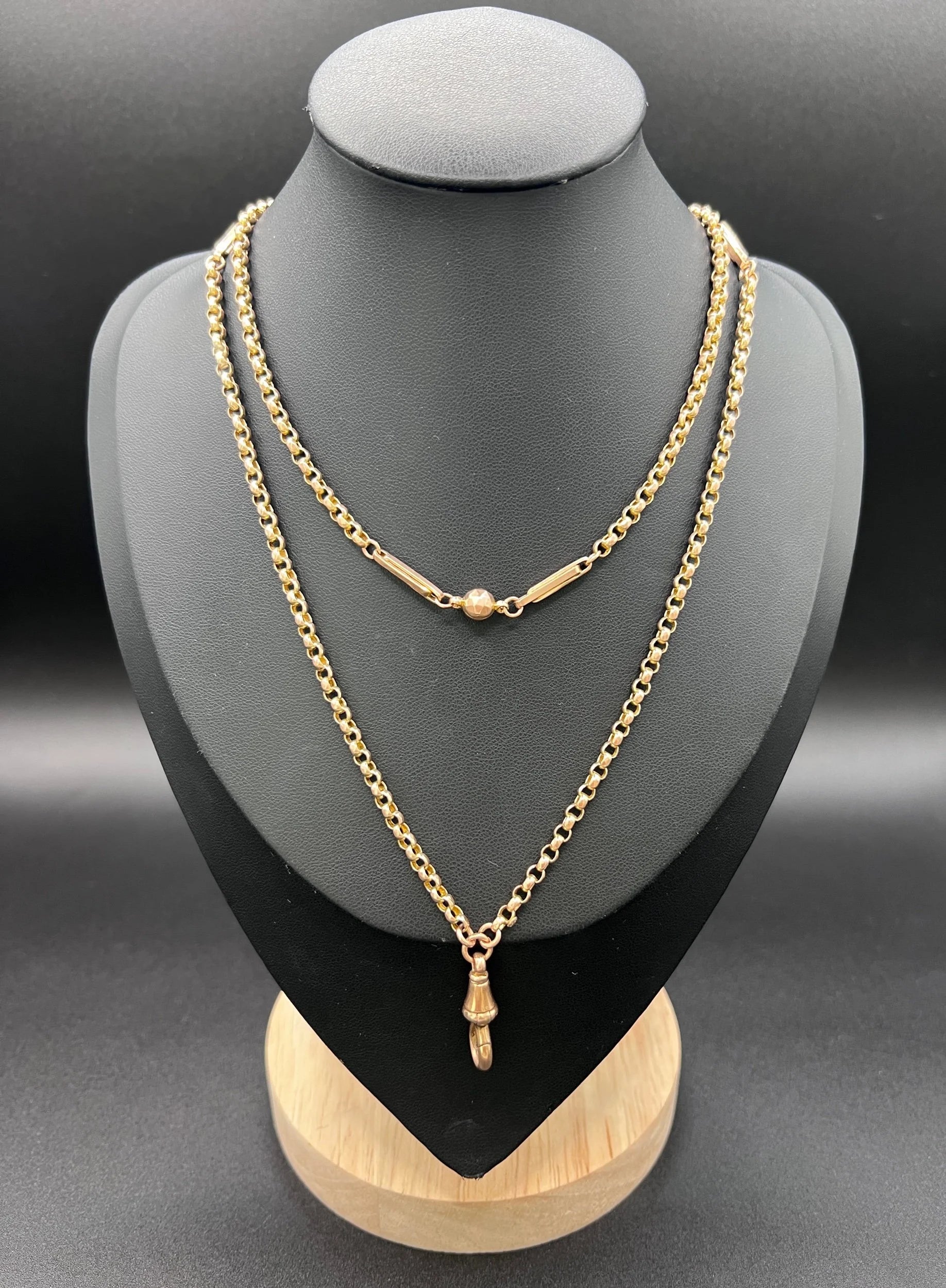 A long rose gold chain necklace with a dog clip clasp