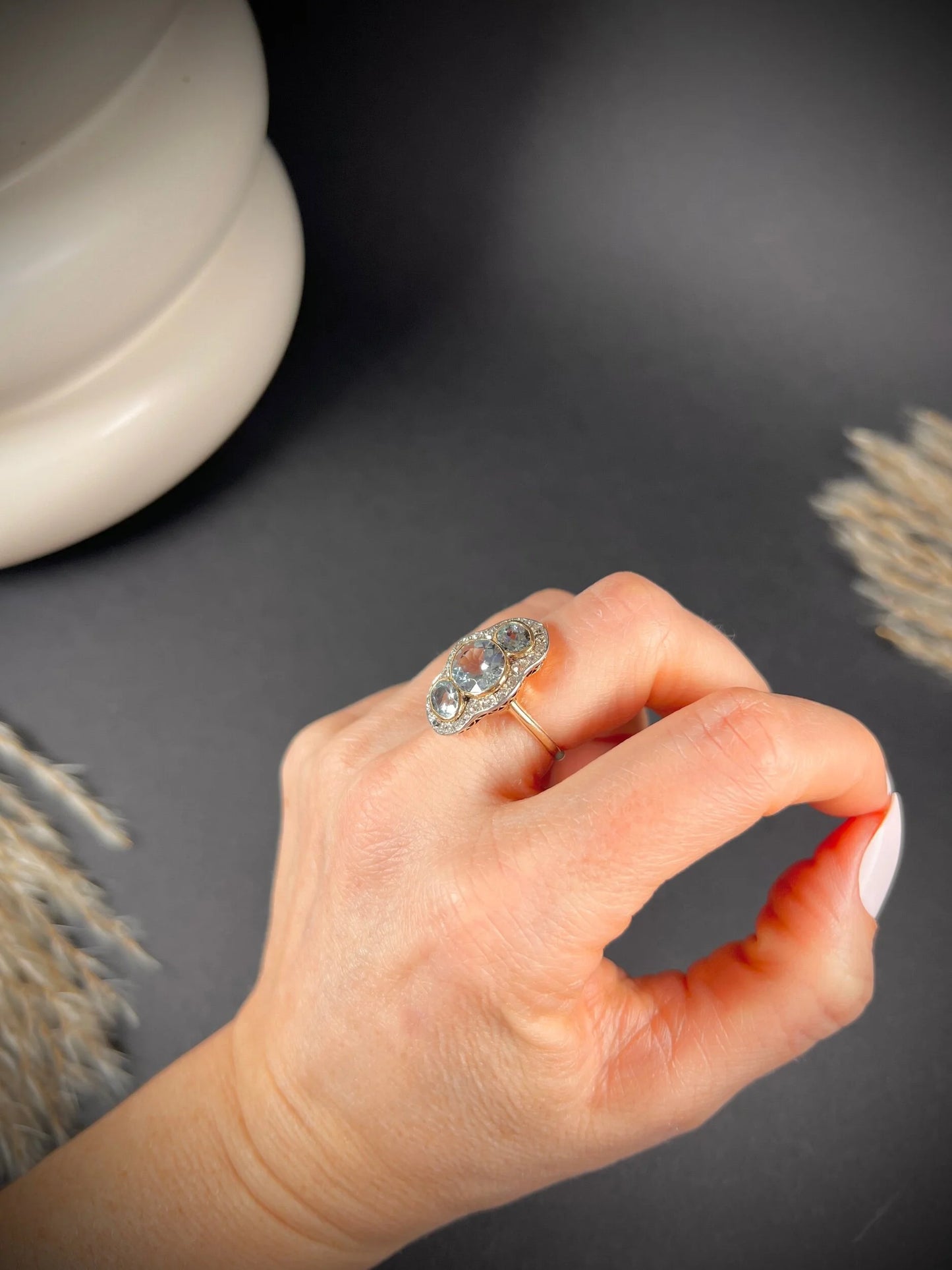An aquamarine and diamond cocktail cluster ring, modelled on a hand