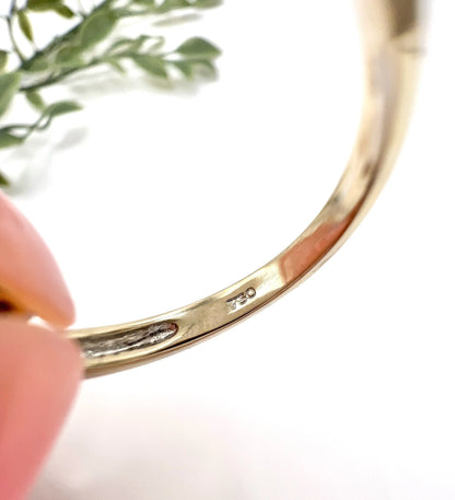 Close-up of stamps inside a white gold ring shank