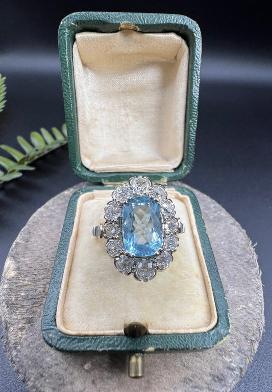 Vintage 2ct Aquamarine and Diamond Cluster Engagement Ring, oval aquamarine surrounded by 2cts sparkling diamonds set in white gold to 18ct yellow gold band with elegant pinched shoulders. Circa 1960s