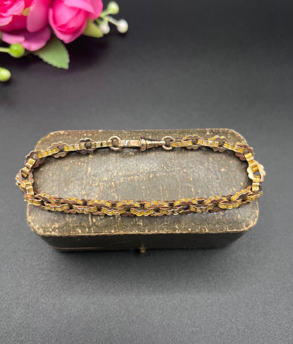 A fancy link yellow gold bracelet with a lobster claw clasp
