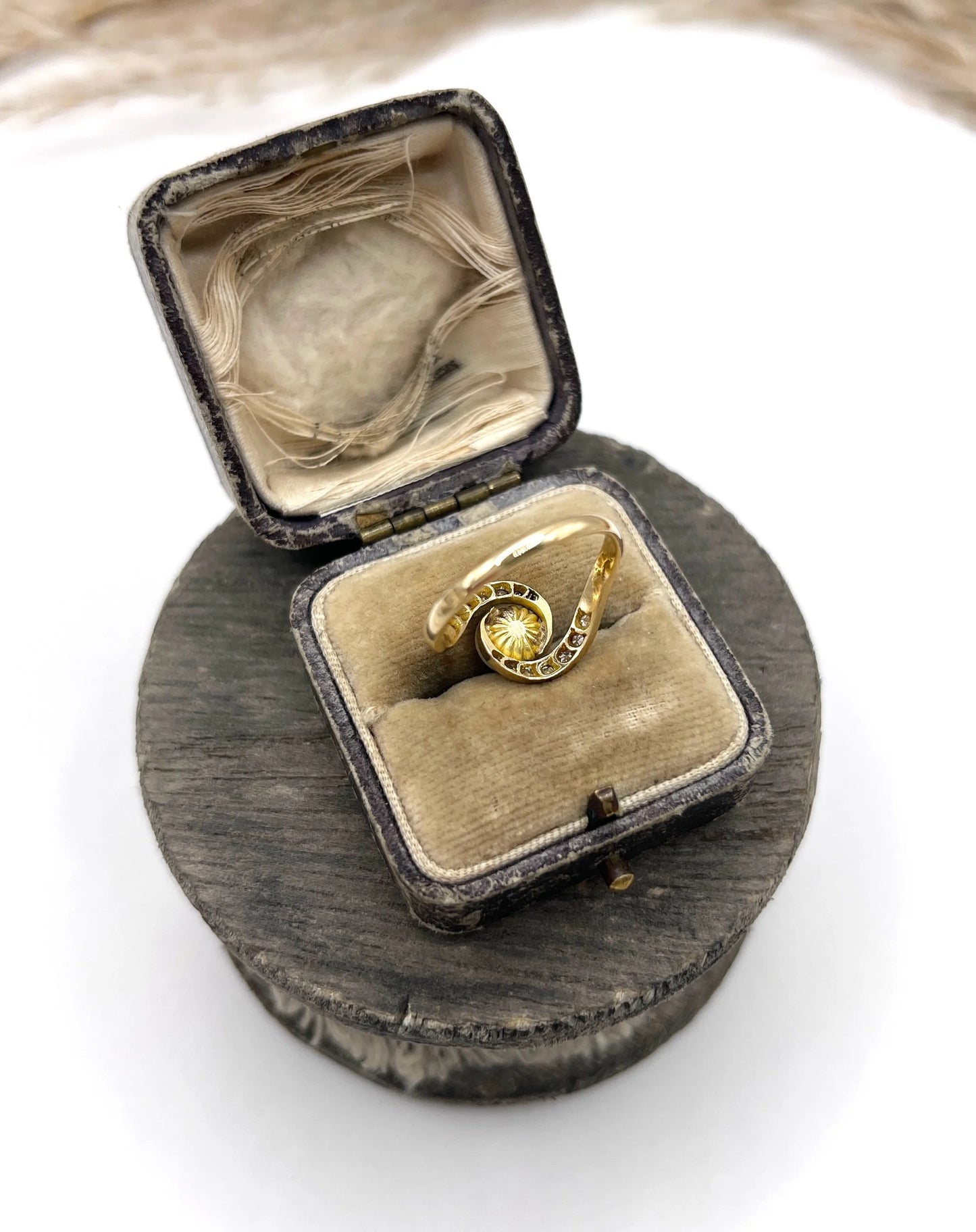 A pearl and diamond crossover swirl ring in yellow and white gold, in an antique ring box