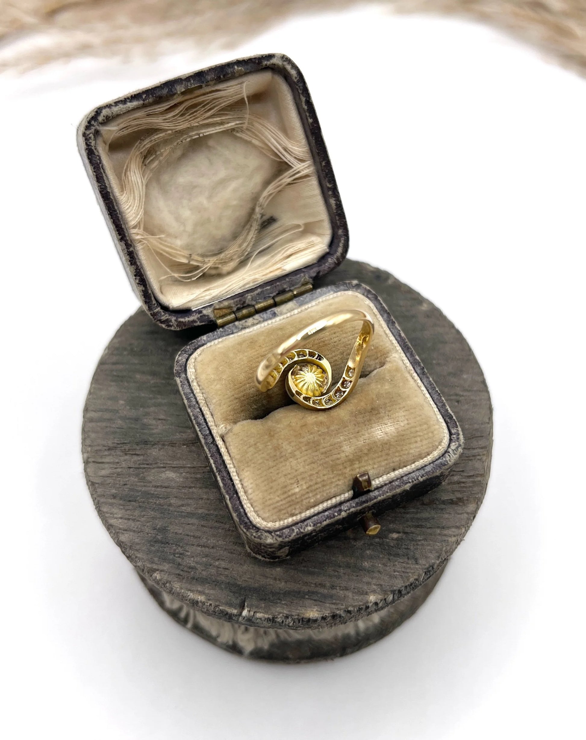 A pearl and diamond crossover swirl ring in yellow and white gold, in an antique ring box