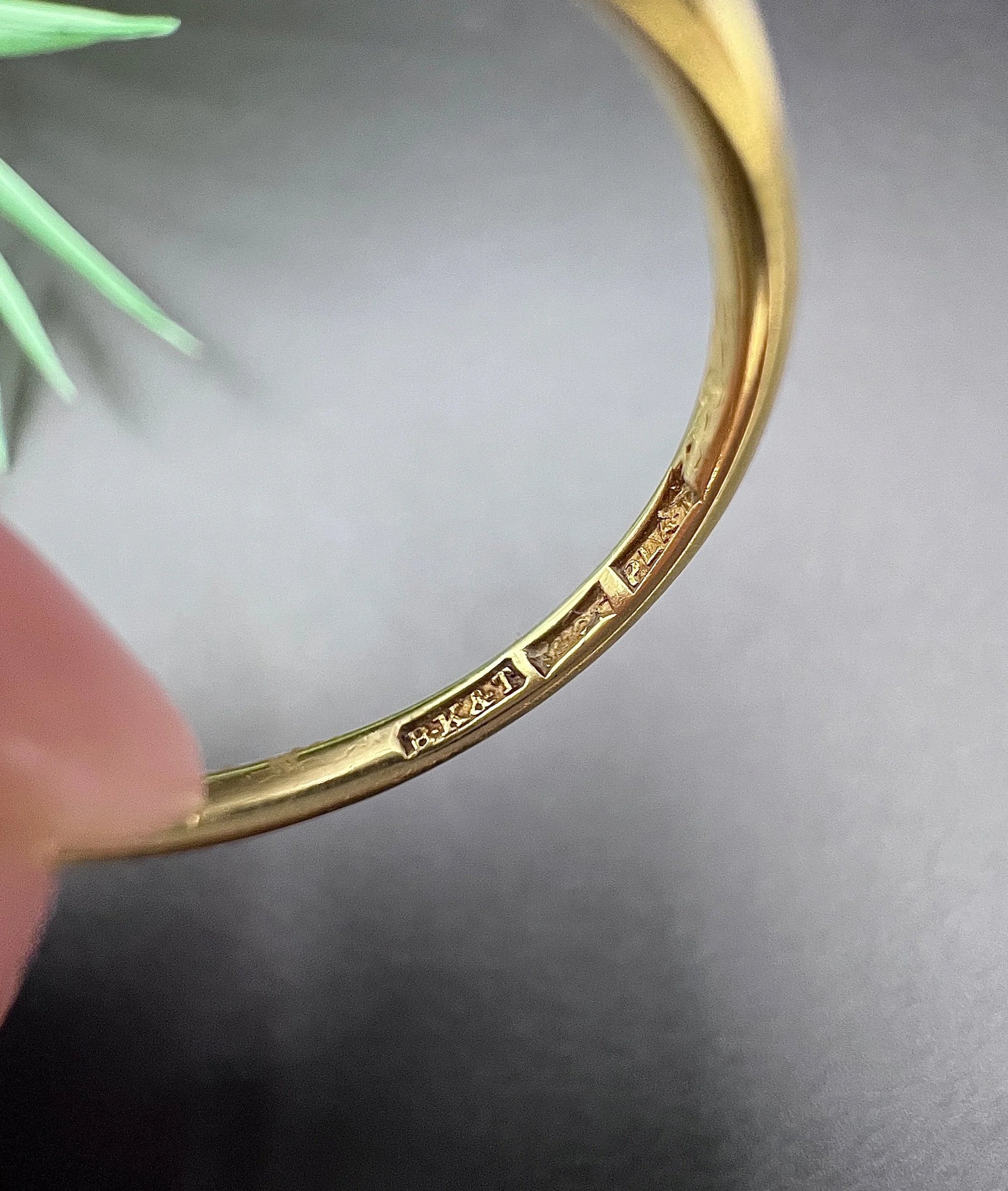 Stamps inside a yellow gold ring shank