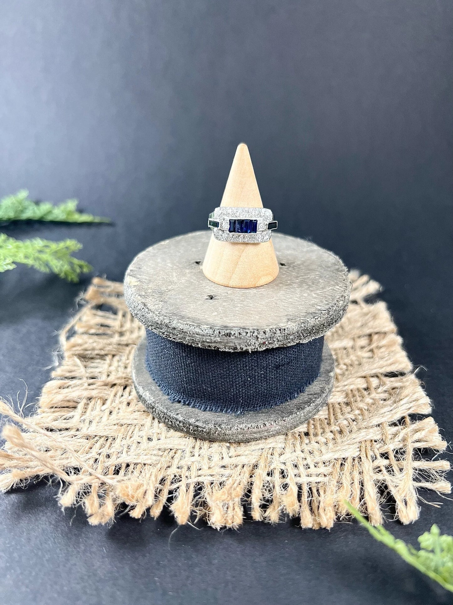 A sapphire and diamond cocktail ring in platinum on a ring cone