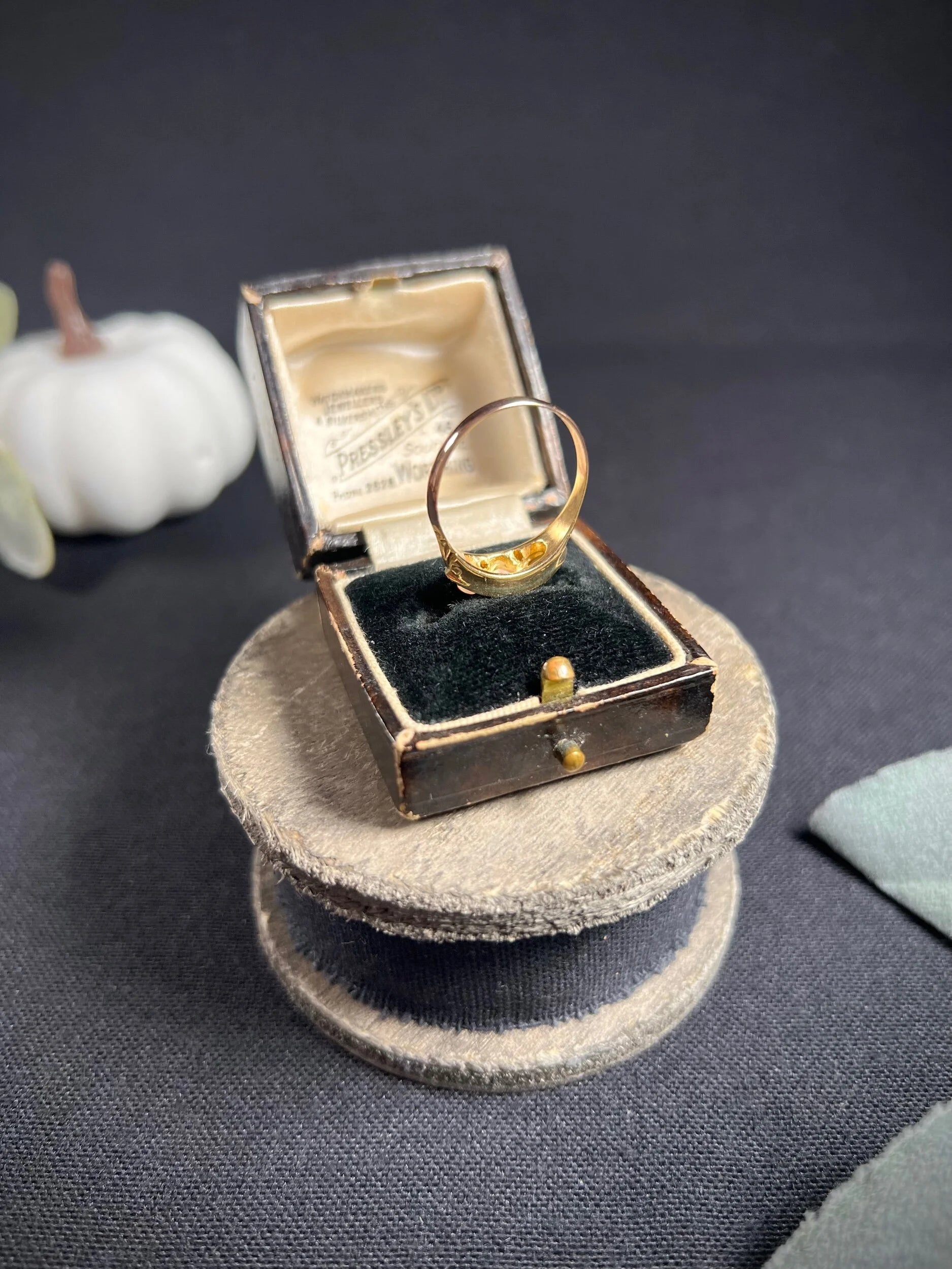 A boat-shaped gold ring with opals and diamonds, in a ring box
