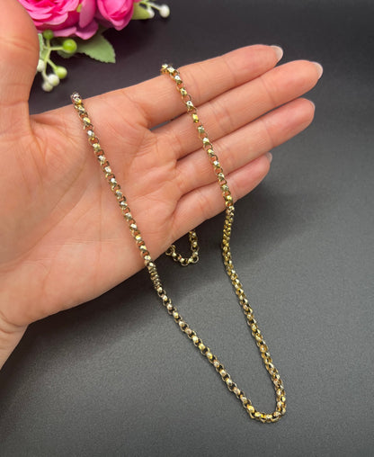 A yellow gold belcher link chain necklace, held in a hand