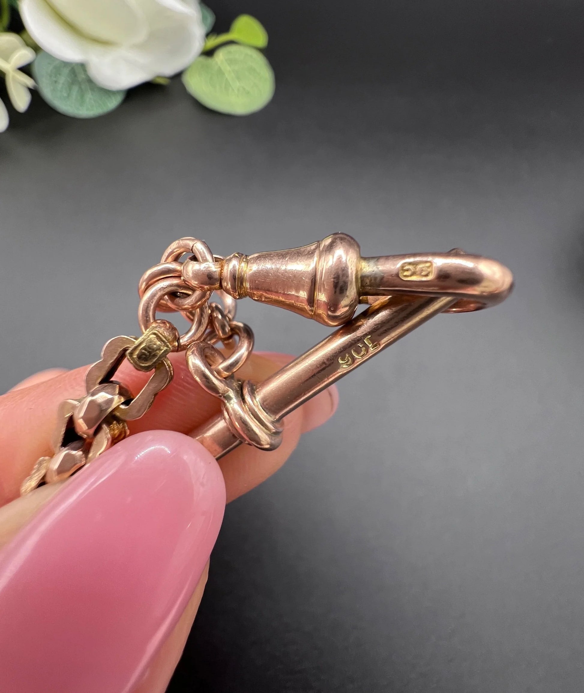 A fancy link rose gold bracelet with a T-bar and dog clip clasp, stamped