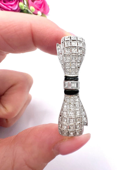 Art Deco 14 Carat White Gold Onyx and Diamond Bow Brooch, Circa 1920