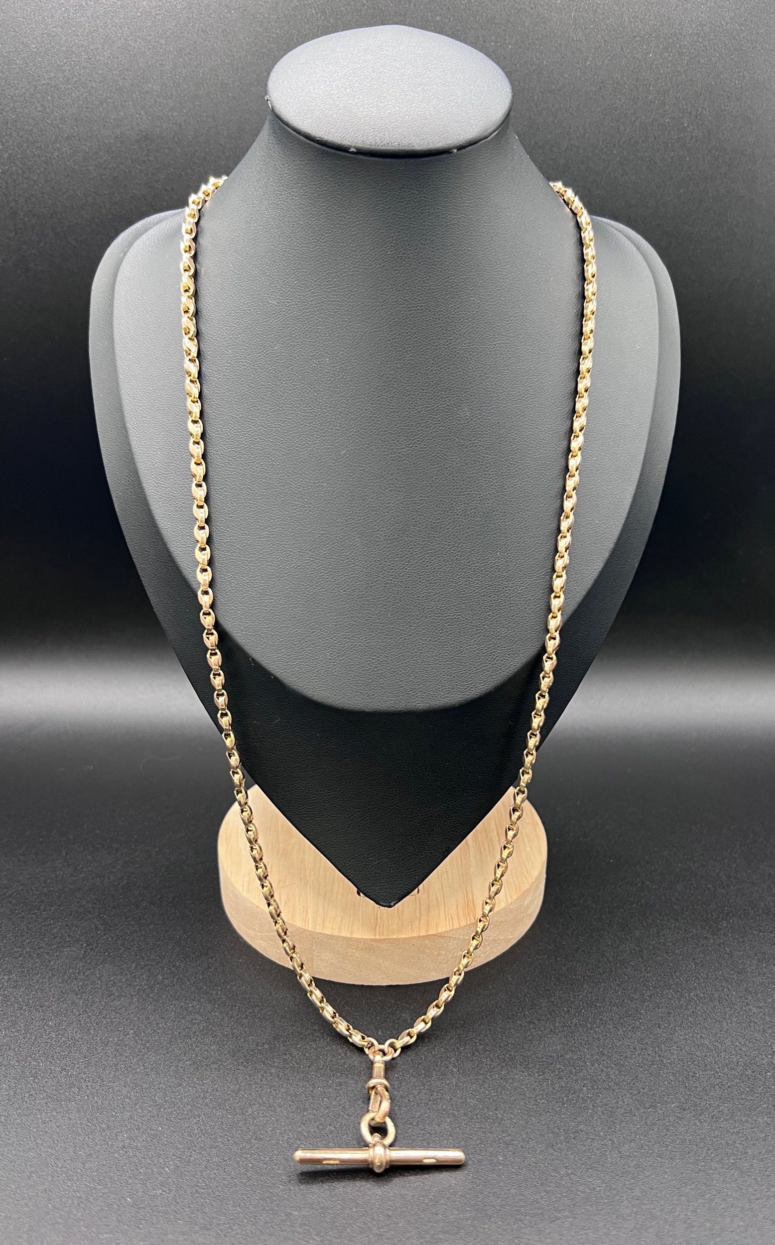 A rose gold tulip link chain necklace with a dog clip clasp and T-bar