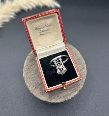 An Art Deco design sapphire and diamond ring in white gold, in a red antique ring box