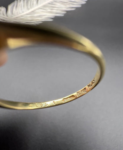 Close-up of 18CT PLAT stamps inside a yellow gold ring shank