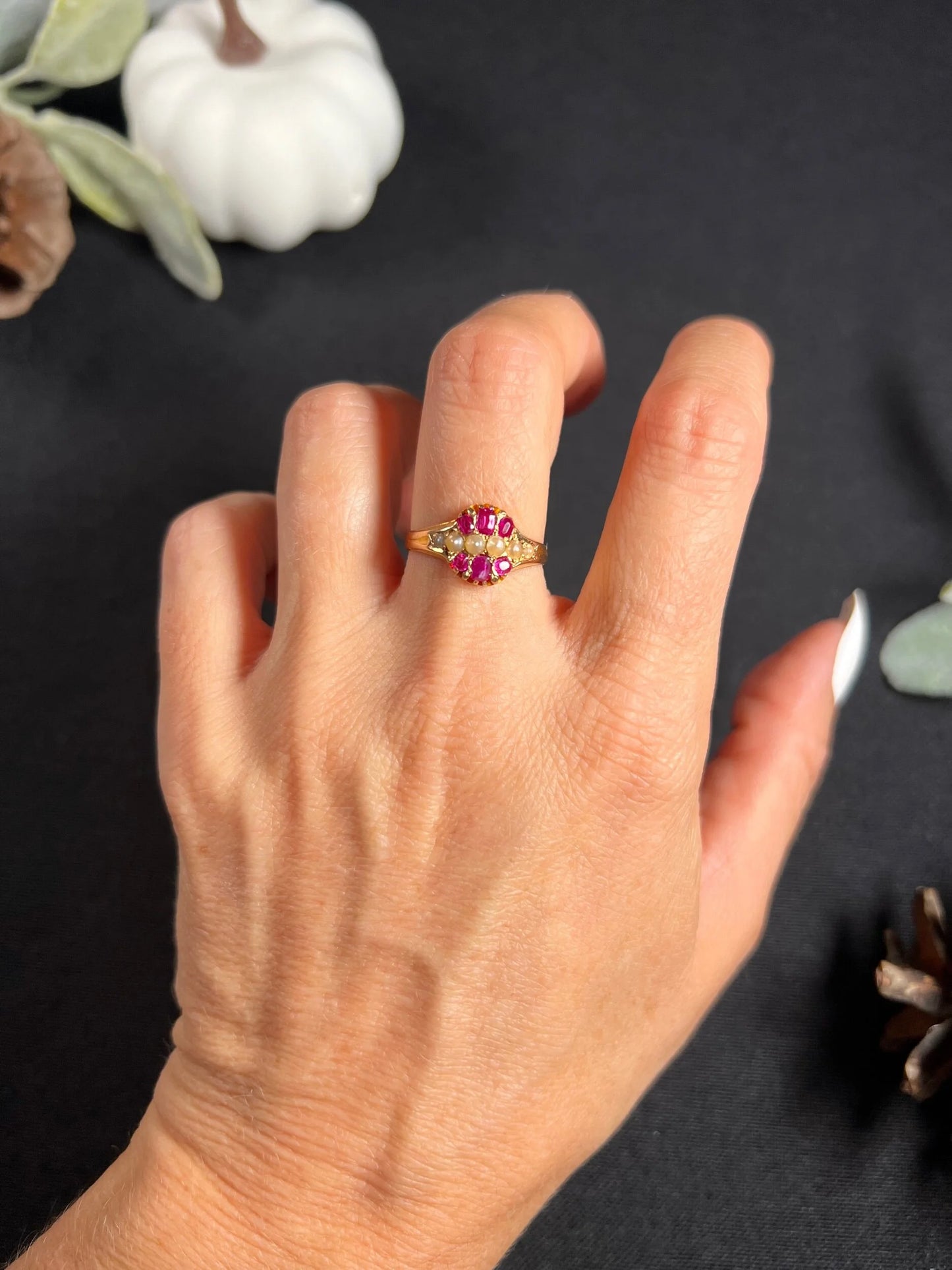 A yellow gold ruby and pearl cluster ring, modelled on a hand