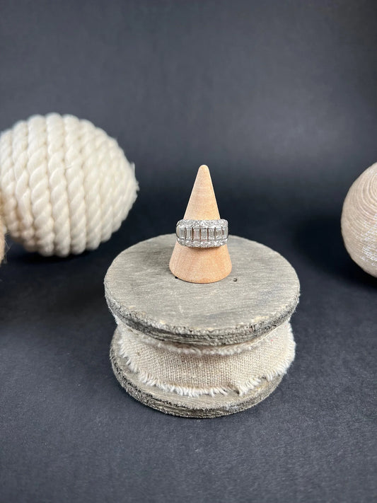 A three row diamond band ring in platinum on a ring cone