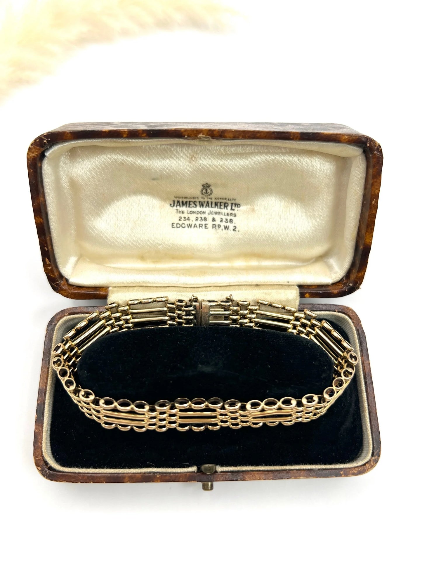 A yellow gold gate bracelet, in an antique box