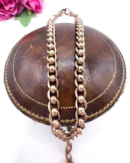 A rose gold fancy link Albert chain necklace with a T-bar attachment