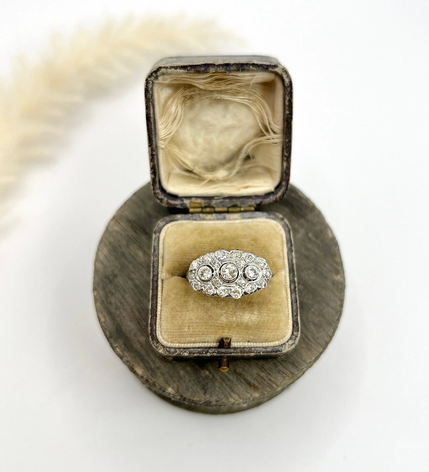 A diamond triple cluster ring in yellow and white gold, in a ring box