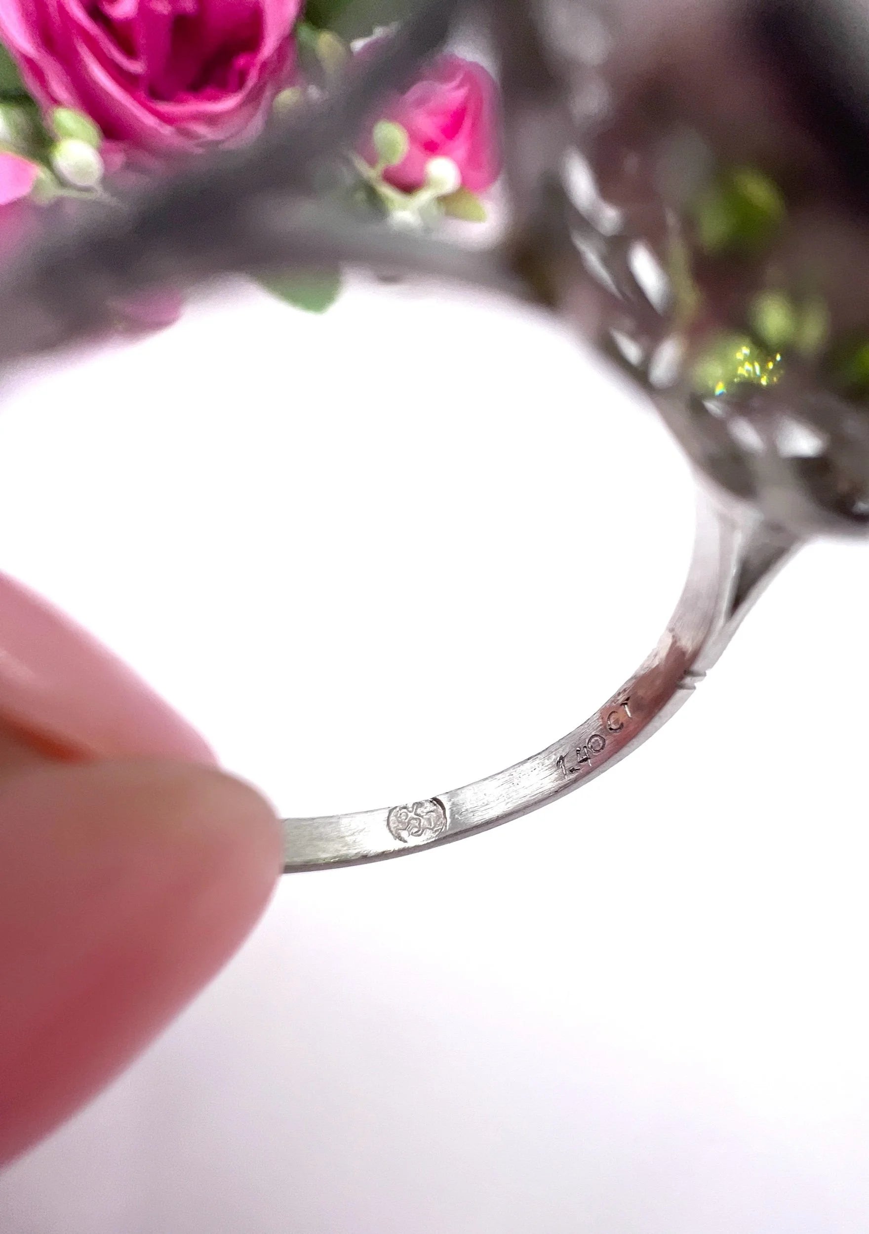 Close-up of stamps inside a white gold ring shank