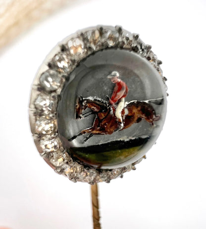 An antique Essex glass and diamond stick pin depicting a jockey riding a horse