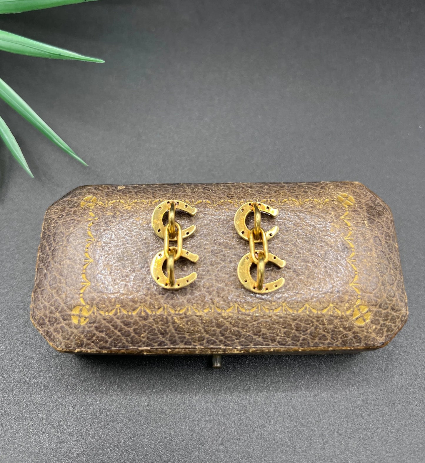 A pair of double-sided horseshoe cufflinks in yellow gold