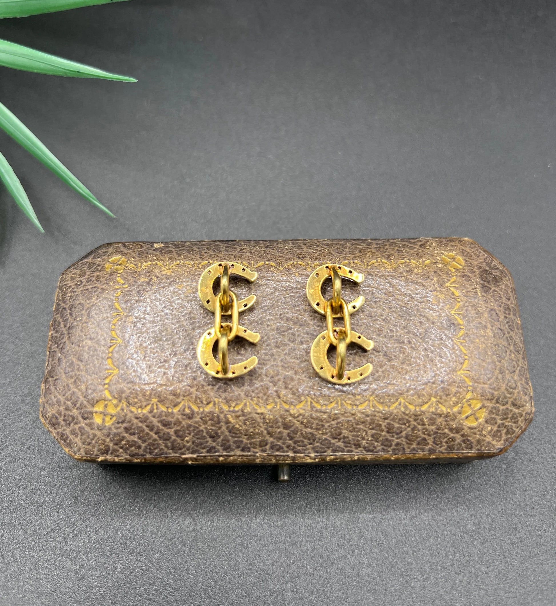 A pair of double-sided horseshoe cufflinks in yellow gold