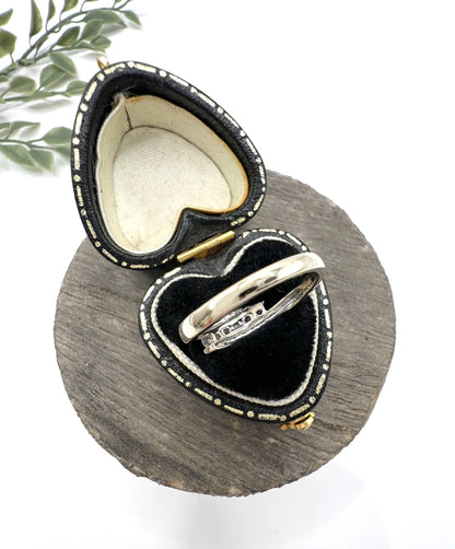 A five stone brilliant cut diamond ring in white gold, in a heart-shaped ring box