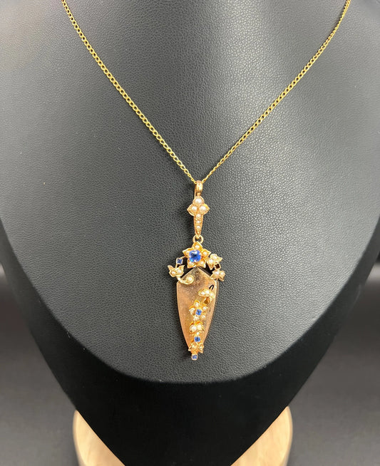 A yellow gold sapphire and pearl floral drop pendant, with a chain