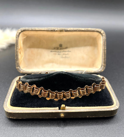 A rose gold fancy link bracelet, in an antique bracelet box