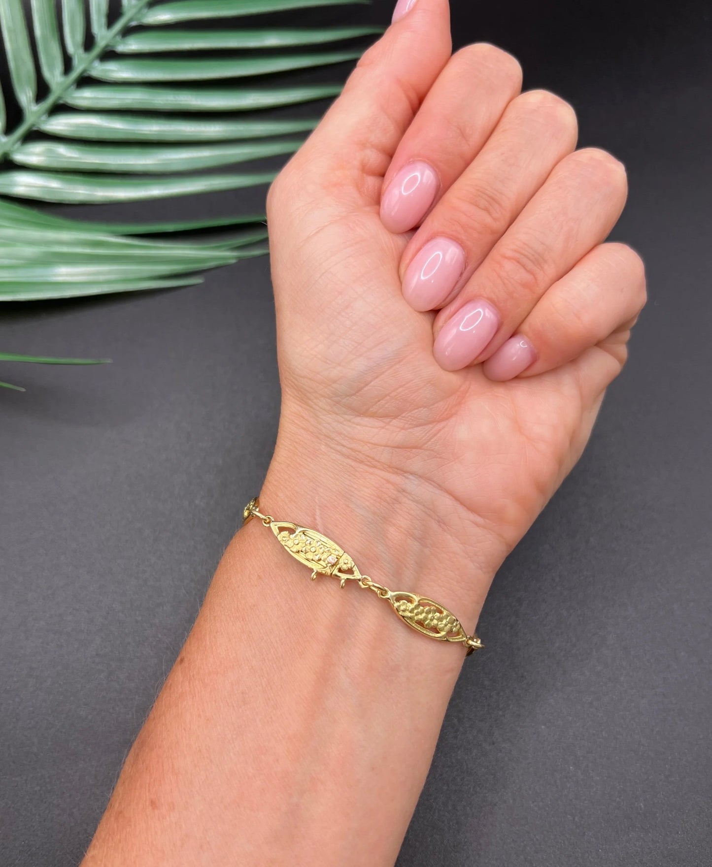 A yellow gold floral link bracelet, modelled on a wrist