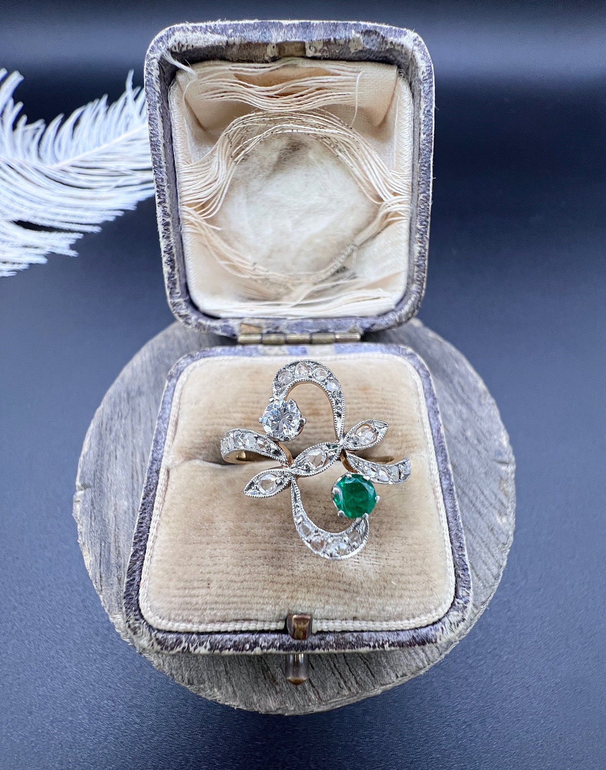 An emerald and diamond fancy openwork ring in yellow gold and platinum, in an antique ring box