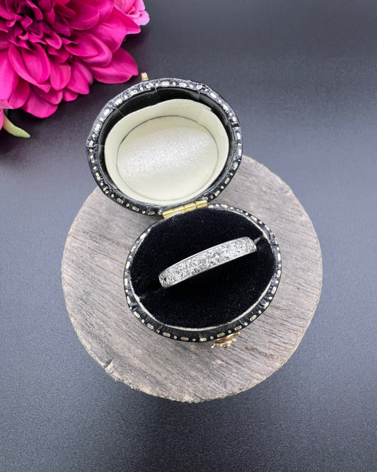 A platinum diamond set half eternity band ring, in a ring box