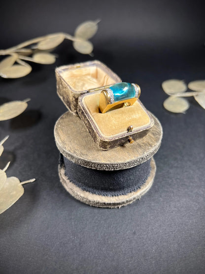 A blue topaz and diamond ring in yellow gold, in an antique ring box