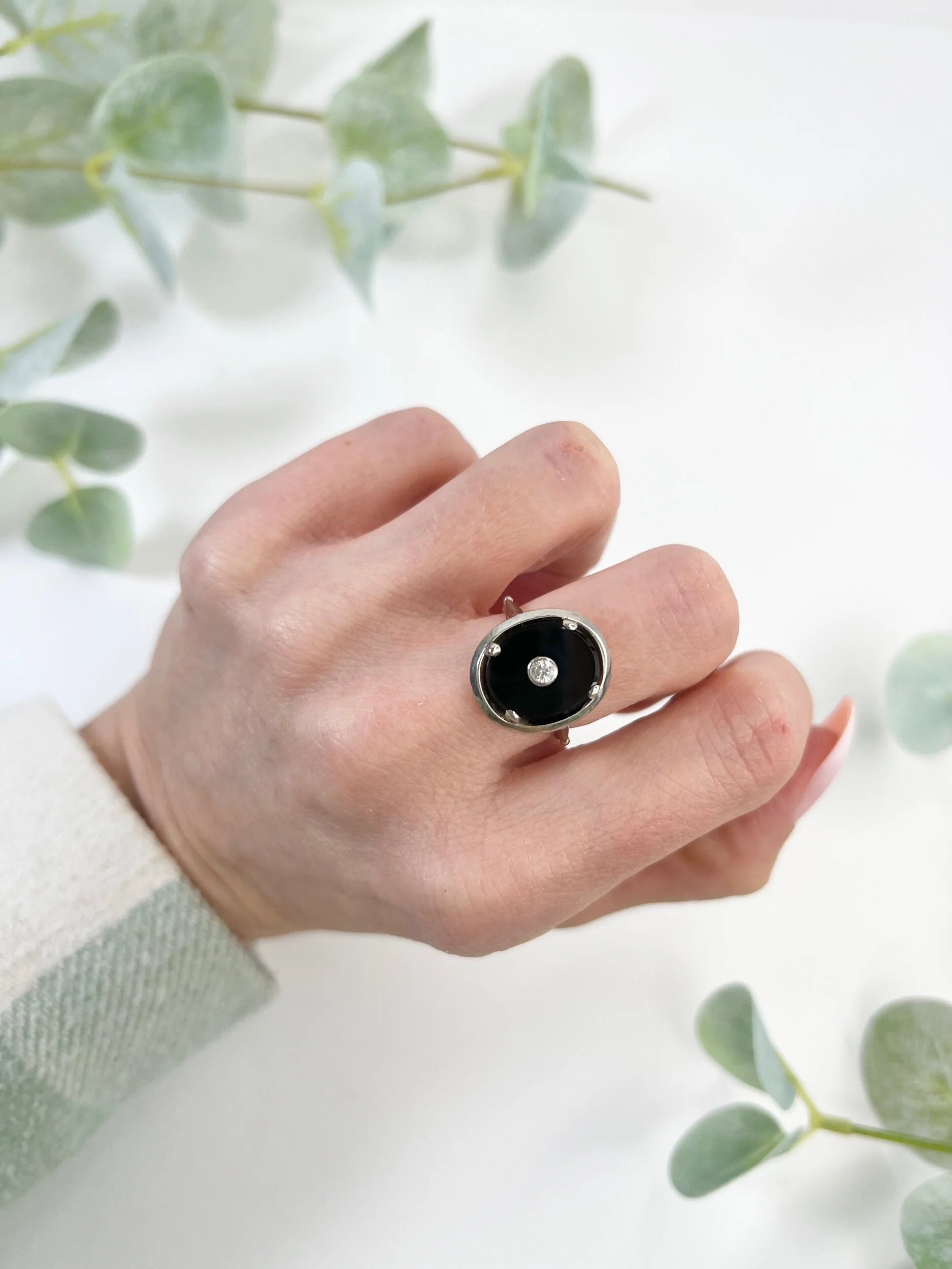 Art Deco 18 Carat Two Colour Gold Oval Onyx and Diamond Halo Ring, Circa 1920